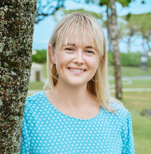 Maddy Flowers Occupational Therapist smiling woman wearing a blue top